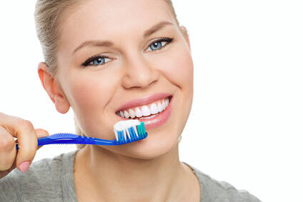 Pretty woman with toothbrush and paste. Healthy teeth concept.